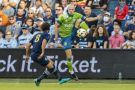 Seattle Sounders defender Brad Smith leaps up to bring down the ball during the first half of an MLS soccer match against the Seattle Sounders, Sunday, Sept. 26, 2021, in Kansas City, Kan. (AP Photo/Nick Tre. Smith)