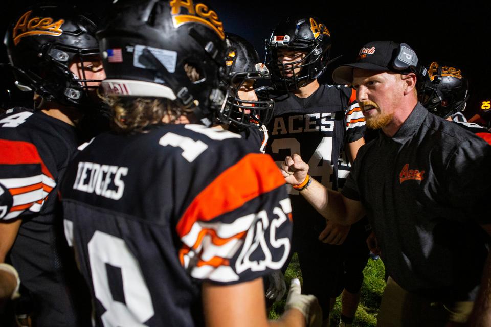 The Amanda-Clearcreek football team gets instructions from a coach during a time out as they took on Jonathan Alder in high school football at Amanda-Clearcreek High School in Amanda, Ohio on August 20, 2021.