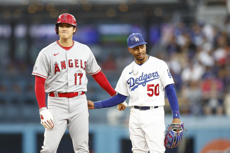 Shohei Ohtani and Mookie Betts stand together.