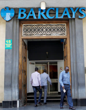 Customers are seen at the entrance of the banking hall after Kenya police seized fake currency in a personal safety deposit box at the Queensway branch of Barclays Bank of Kenya, in downtown Nairobi, Kenya March 19, 2019. REUTERS/Njeri Mwangi