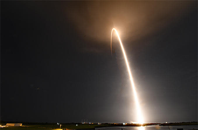 A SpaceX Falcon 9 rocket powered by a first stage making its fifth flight streaked away from Cape Canaveral early Friday, boosting 57 Starlink internet relay stations into orbit along with two commercial remote sensing satellites. A time exposure captures the rocket's fiery trajectory as it climbed away from the Kennedy Space Center. / Credit: William Harwood/CBS News