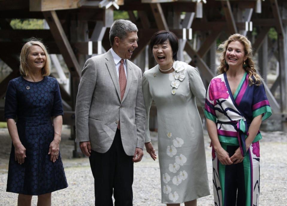 Partners of the G-7 summit participants Christiane Juncker, wife of European Commission President Jean-Claude Juncker, left, Joachim Sauer, husband of German Chancellor Angela Merkel, second left, Akie Abe, wife of Japanese Prime Minister Shinzo Abe, second right, and Sophie Gregoire-Trudeau, wife of Canada’s Prime Minister Justin Trudeau, exhange smiles as they pose for a photograph next to the Ujibashi bridge during a visit to the Ise Jingu shrine in Ise, Mie prefecture, Japan, Thursday, May 26, 2016, ahead of the first session of the G-7 summit meetings. The leaders of the G-7 nations have arrived for a visit at Ise Jingu, the most hallowed site for Japan’s indigenous Shinto religion. (Toru Hanai/Pool Photo via AP)