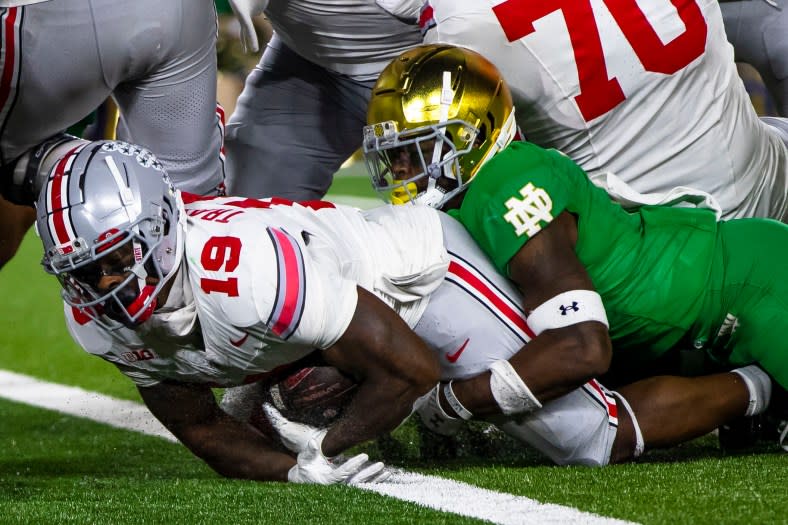 Ohio State running back Chip Trayanum (19) scores as Notre Dame safety DJ Brown (2) tries to stop him during the second half of an NCAA college football game Saturday, Sept. 23, 2023, in South Bend, Ind. (AP Photo/Michael Caterina)