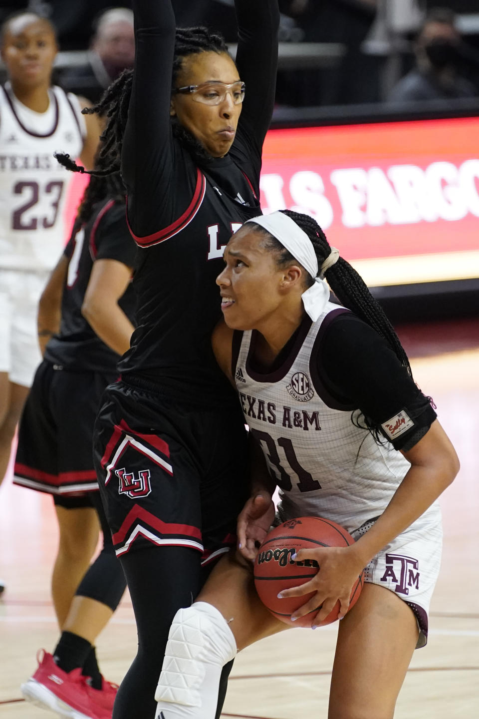 Texas A&M forward N'Dea Jones (31) looks to shoot against Lamar forward Micaela Wilson (12) during the second half of an NCAA college basketball game Wednesday, Nov. 25, 2020, in College Station, Texas. (AP Photo/Sam Craft)