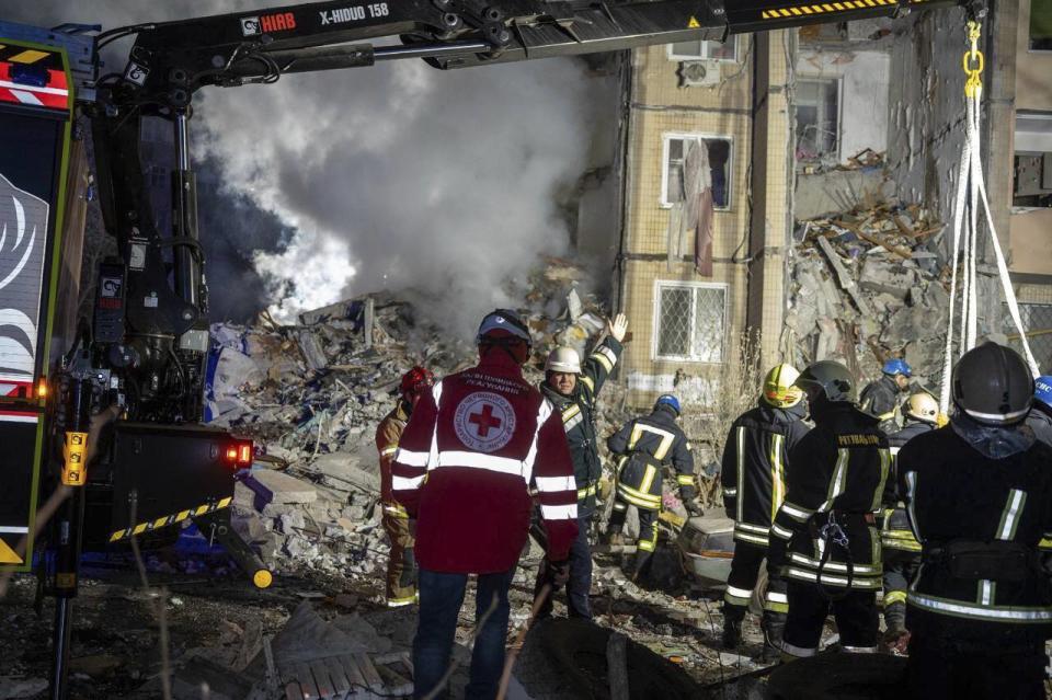 In this photo provided by the Ukrainian Emergency Service, emergency workers clear the rubble on the site of a destroyed multi-store building after a Russian attack on residential neighbourhood in Odesa, Ukraine, Saturday, March 2, 2024. (Ukrainian Emergency Service Office via AP)