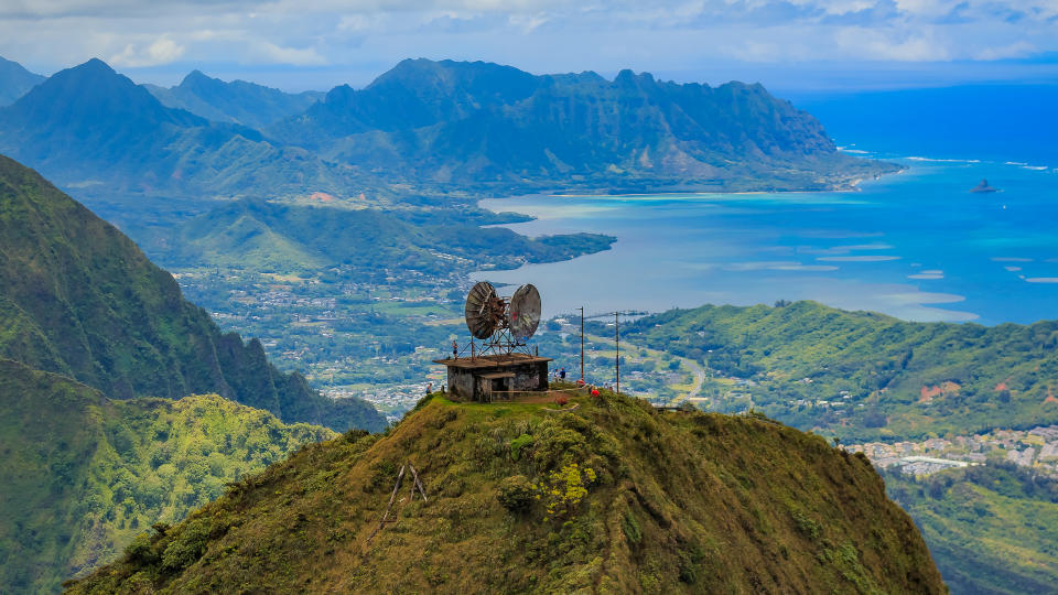 The World War 2 communication tower built by the US navy atop a mountain on Oahu with the ocean behind it