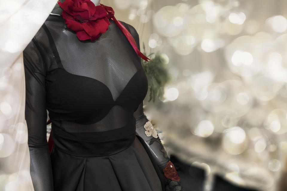 black women's dress detail, With a red flower on her neck