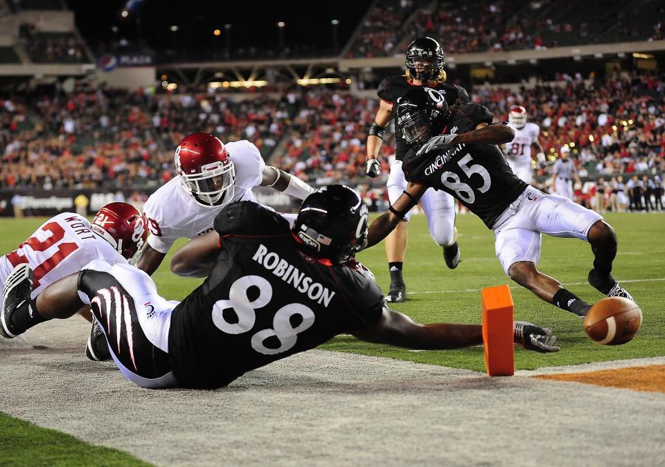 Sept. 25, 2010; Cincinnati, OH, USA; Cincinnati Bearcats tight end Adrien Robinson (88) dives for the pylon for a touchdown as Oklahoma Sooners cornerback Demontre Hurst (19) is late on the coverage during the fourth quarter at Paul Brown Stadium.