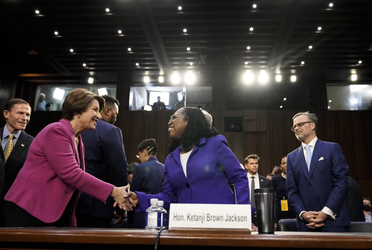 Sen. Amy Klobuchar (D-MN) (L) shakes hands with U.S. Supreme Court nominee Judge Ketanji Brown Jackson during her confirmation hearing before the Senate Judiciary Committee in the Hart Senate Office Building on Capitol Hill on March 21, 2022, in Washington, DC.