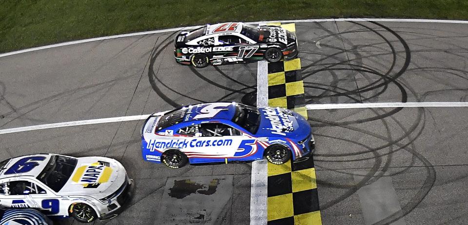 KANSAS CITY, KANSAS - MAY 05: Kyle Larson, driver of the #5 HendrickCars.com Chevrolet, takes the checkered flag over Chris Buescher, driver of the #17 Castrol Edge Ford, to win the NASCAR Cup Series AdventHealth 400 at Kansas Speedway on May 05, 2024 in Kansas City, Kansas. (Photo by Logan Riely/Getty Images) ORG XMIT: 776141105 ORIG FILE ID: 2151635861