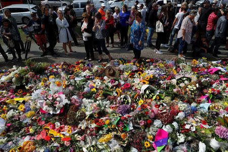 People visit a memorial site for victims of Friday's shooting, in front of Christchurch Botanic Gardens in Christchurch, New Zealand March 19, 2019. REUTERS/Jorge Silva