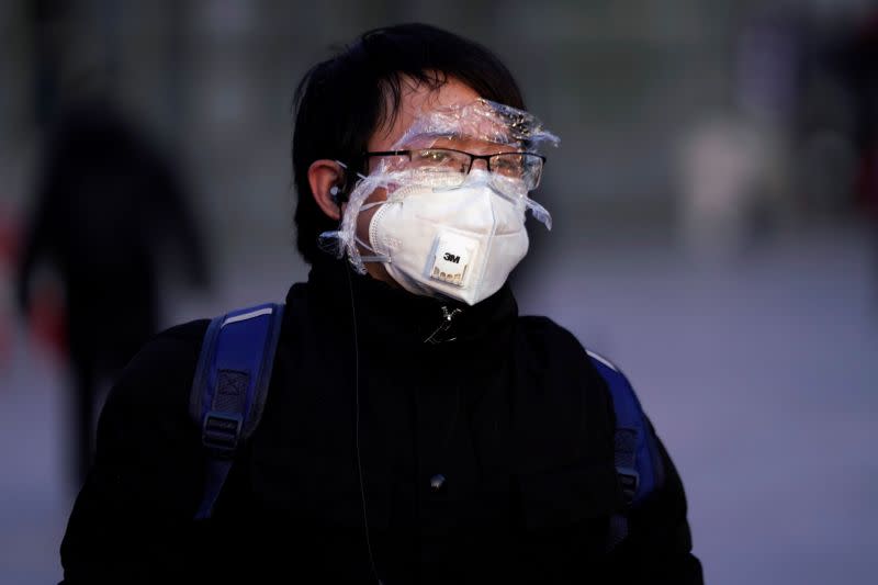 Passenger wearing a mask walks at the Shanghai railway station