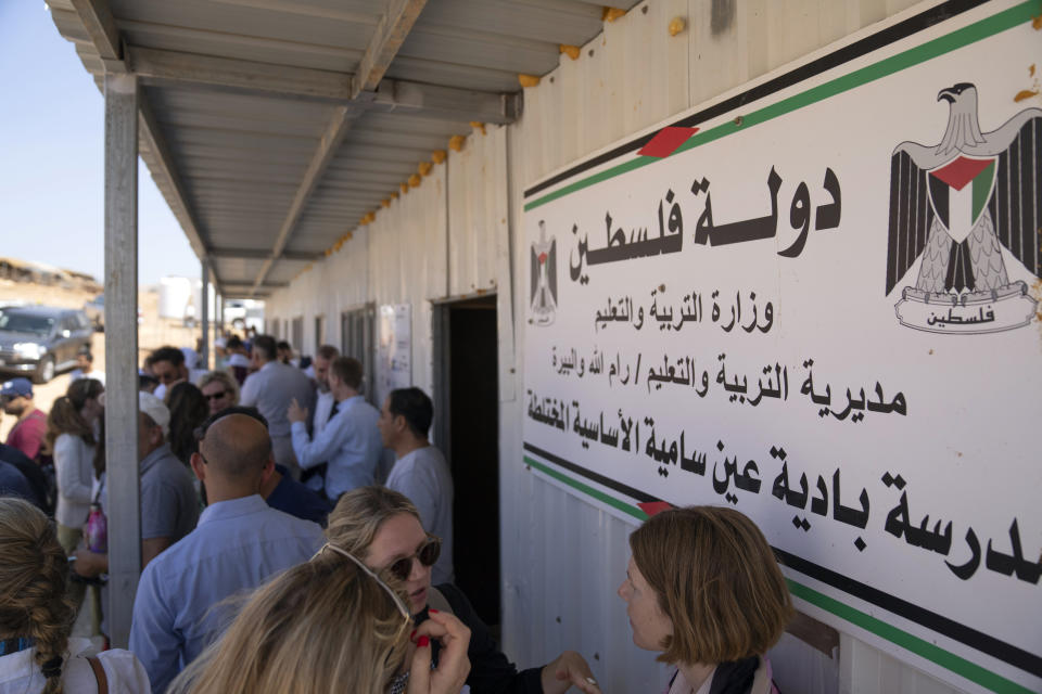 A school sign that reads "state of Palestine, ministry of education, Ein Samia school," is displayed as the European Union representatives visit the school structure that is under the threat of demolition by the Israeli authorities, in the West Bank Bedouin community of Ein Samia, northeast of Ramallah, Friday, Aug. 12, 2022. The Israeli District Court in Jerusalem issued on Wednesday, Aug. 10, a decision to immediately demolish the Ein Samia school. Fifty four schools serving seven thousand Palestinian children in the West Bank's area "C" are under threat of demolition, Sven Kühn von Burgsdorff, the European Union's representative to the West Bank and Gaza told reporters. (AP Photo/Nasser Nasser)