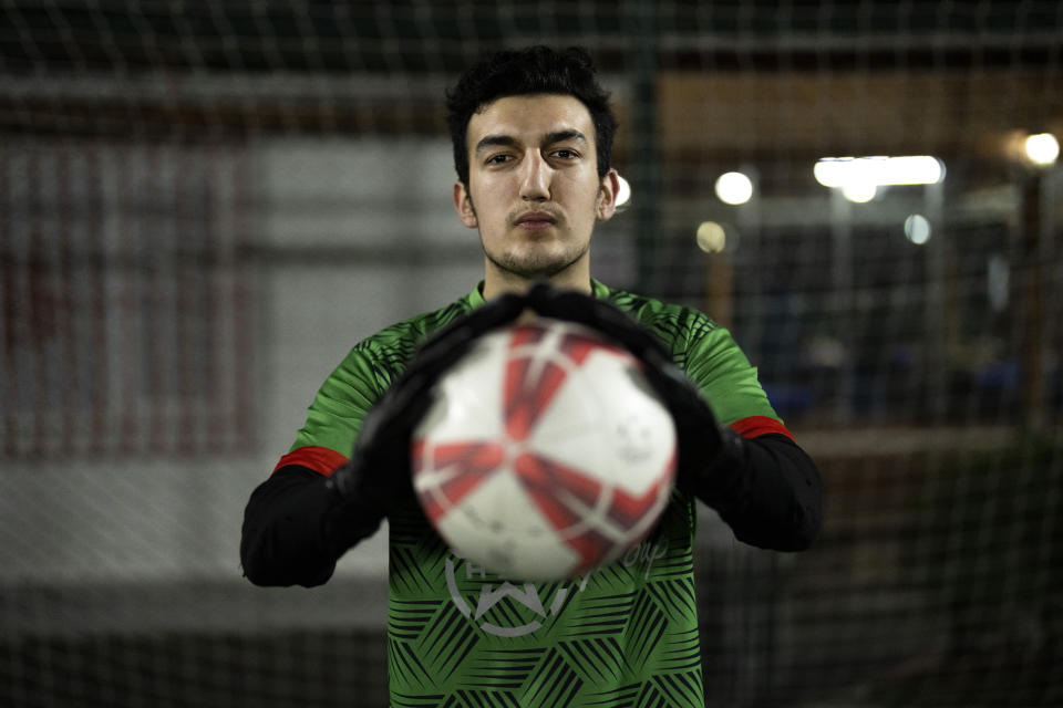 Amateur goalkeeper Mustafa Mert Olcer poses for a photograph after a recreational soccer "Astroturf" match in Istanbul, Turkey, Tuesday, March 5, 2024. More than a few times a week, the 18-year-old courier and passionate goalkeeper Mustafa Mert Olcer, gets a call from Rent-a-Goalkeeper to man a goalpost. (AP Photo/Francisco Seco)