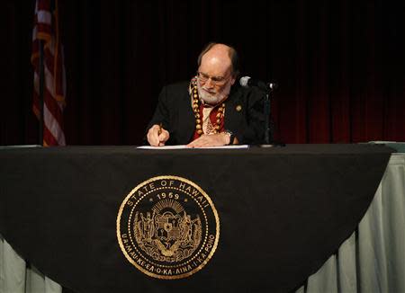 Hawaii Governor Neil Abercrombie signs Senate Bill 1, allowing same sex marriage to be legal in the state, in Honolulu, Hawaii November 13, 2013. REUTERS/Hugh Gentry