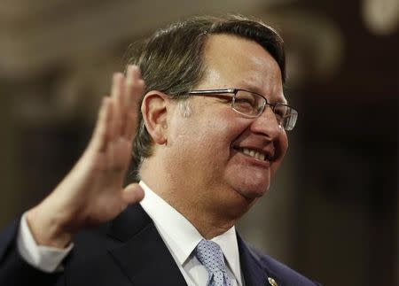 U.S. Senator Gary Peters (D-MI) smiles as he is ceremonially sworn-in by Vice President Joseph Biden in the Old Senate Chamber on Capitol Hill in Washington January 6, 2015. REUTERS/Larry Downing