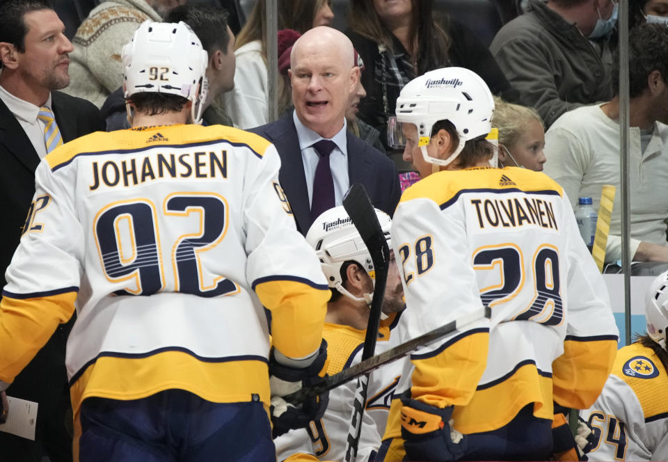 Nashville Predators head coach John Hynes, center, talks with center Ryan Johansen, left, and right wing Eeli Tolvanen in the second period of an NHL hockey game against the Colorado Avalanche Saturday, Nov. 27, 2021, in Denver. (AP Photo/David Zalubowski)