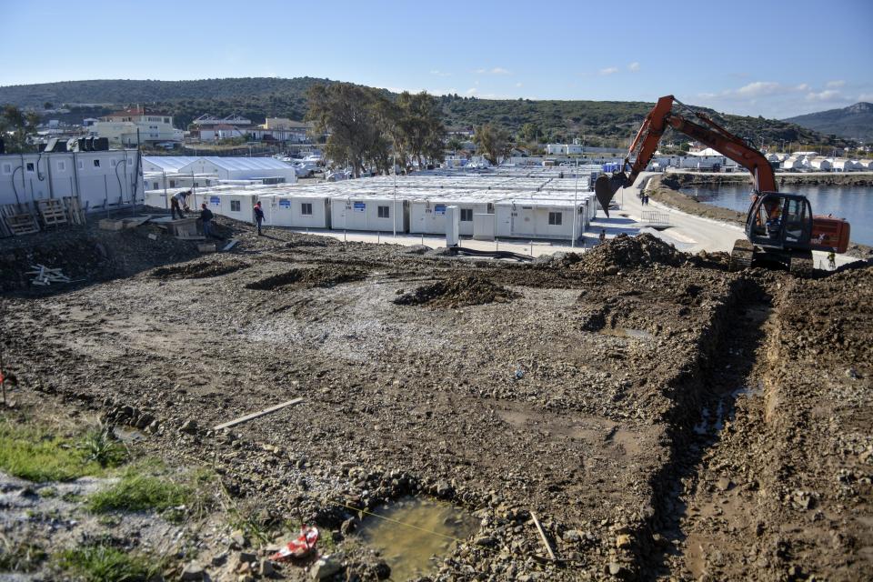 A heavy machine prepares the area where Pope Francis will deliver a speech and meet migrants at Karatepe refugee camp, on the northeastern Aegean island of Lesbos, Greece, Thursday, Nov. 25, 2021. Pope Francis is heading back to the Greek island of Lesbos to meet migrants and asylum seekers for the second time in five years. (AP Photo/Panagiotis Balaskas)