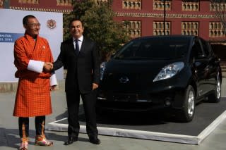 Tshering Tobgay, prime minister of Bhutan, with Nissan CEO Carlos Ghosn and Nissan Leaf electric car