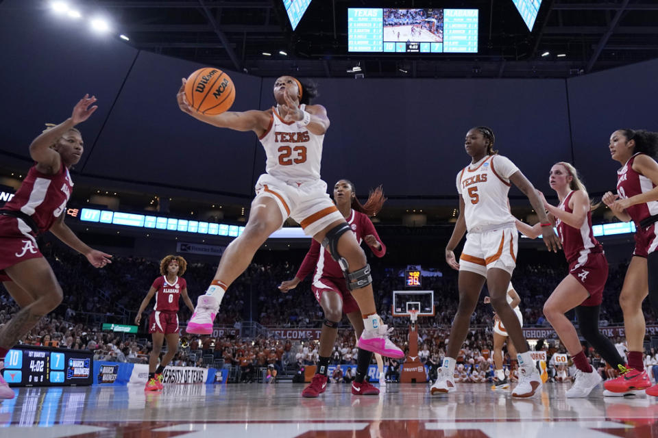 Texas forward Aaliyah Moore (23) grabs a rebound during the first half of a second-round college basketball game against Alabama in the women’s NCAA Tournament in Austin, Texas, Sunday, March 24, 2024. (AP Photo/Eric Gay)