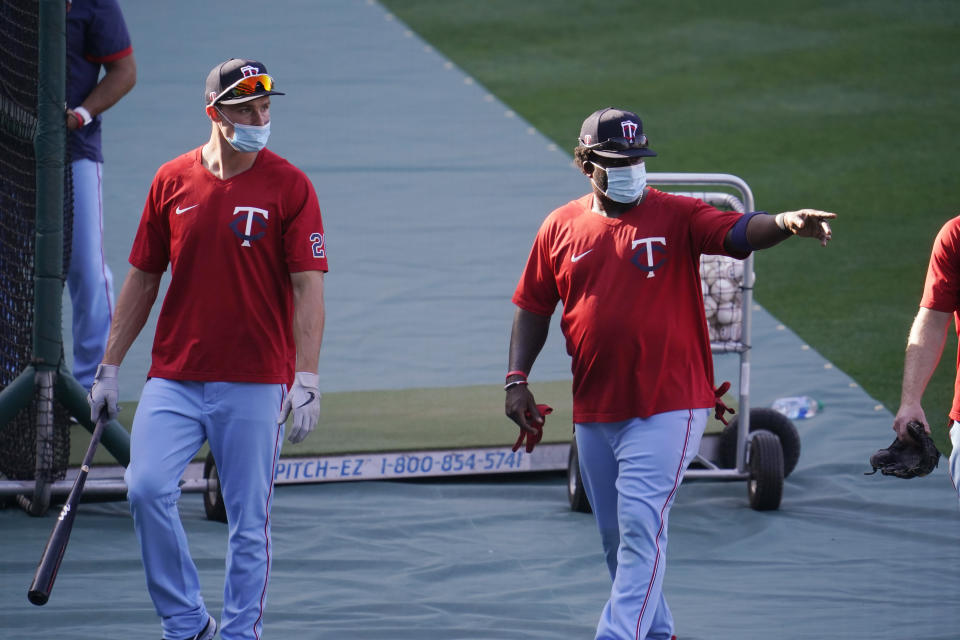 Minnesota Twins players wear masks during batting practice amid the COVID-19 pandemic, before a baseball game against the Los Angeles Angels on Friday, April 16, 2021, in Anaheim, Calif. (AP Photo/Marcio Jose Sanchez)