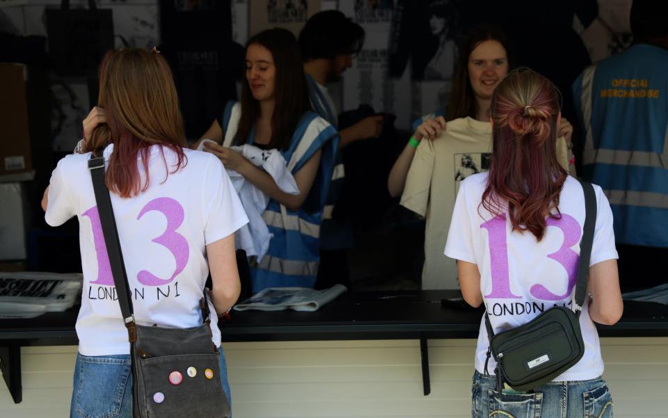 Taylor Swift fans buy merchandise at the first night of the Eras tour at Wembley Stadium