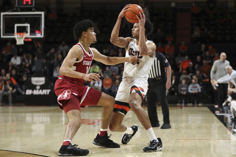 Oregon State forward Michael Rataj (12) looks to pass the ball as Stanford forward Spencer Jones (14) defends during the first half of an NCAA college basketball game in Corvallis, Ore., Thursday, March 2, 2023. (AP Photo/Amanda Loman)