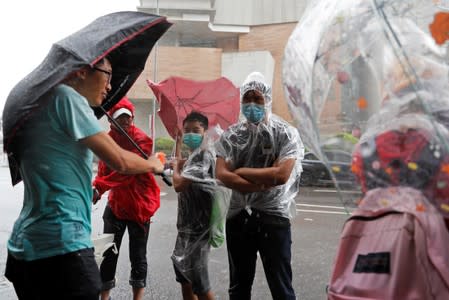 Protesters gather outside the Eastern Courts to support the arrested anti-extradition bill protesters who face rioting charges, as the typhoon Wipha approaches in Hong Kong