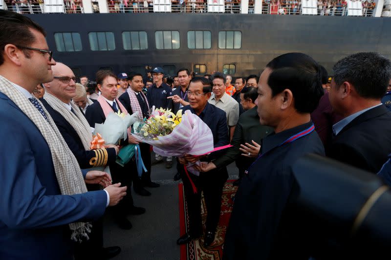 Cambodia's Prime Minister Hun Sen welcomes the passengers and crews of MS Westerdam, a cruise ship that spent two weeks at sea after being turned away by five countries over fears that someone aboard might have the coronavirus , as it docks in Sihanoukvil