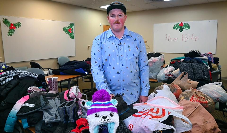 Frostbite survivor Alec Grimes, 28, of Littleton is shown Dec. 16, 2022, with donated outdoor clothing he collected through his cold weather gear drive. The gear is shared with UCHealth patients and the community to help prevent others from experiencing cold weather-related injuries.