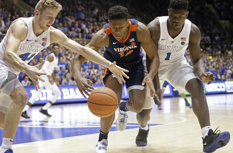 Duke's Jack White (41) and Zion Williamson (1) chase the ball with Virginia's De'Andre Hunter (12) during the first half of an NCAA college basketball game in Durham, N.C., Saturday, Jan. 19, 2019. (AP Photo/Gerry Broome)