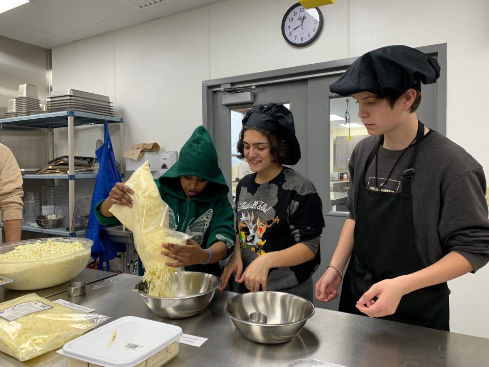 East High School culinary students prepare ingredients for lasagnas they're making for Eats for East at East High School on November 10, 2022 in Green Bay, Wisconsin.