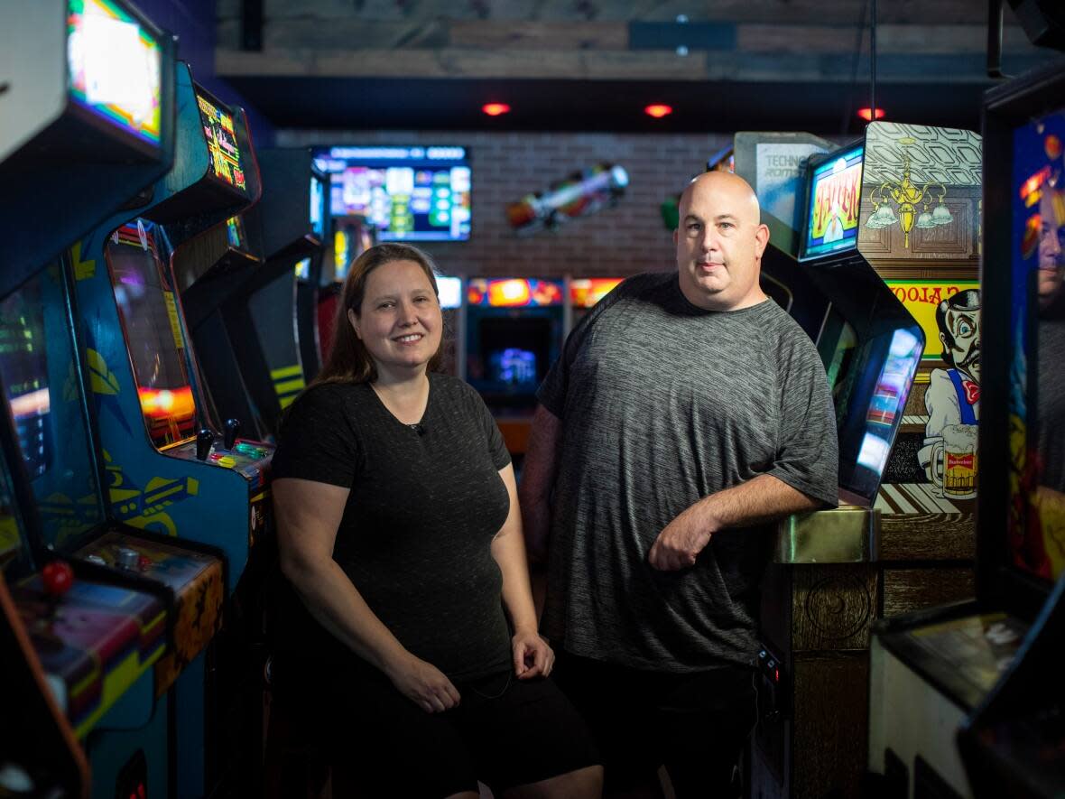 Maryanne Eyers and Brad Eyers own Capital City Classic Arcade in New Westminster, B.C. They say they've finally finished a lengthy licensing process that allows them to sell alcoholic drinks. They feel legal and moral concerns about arcades slowed down the process. (Ben Nelms/CBC - image credit)