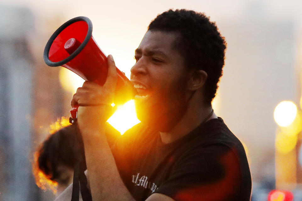 A protest leader chants with demonstrators Sunday, May 31, 2020, after curfew in Minneapolis. Protests continued following the death of George Floyd, who died after being restrained by Minneapolis police officers on Memorial Day. (AP Photo/Julio Cortez)