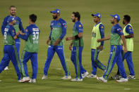 Multan Sultans spinner Shahid Afridi, center, celebrates with teammates after taking the wicket of Lahore Qalandars batsman Mohammad Hafeez during the second eliminator cricket match of Pakistan Super League T20 cup at National Stadium in Karachi, Pakistan, Sunday, Nov. 15, 2020. (AP Photo/Fareed Khan)