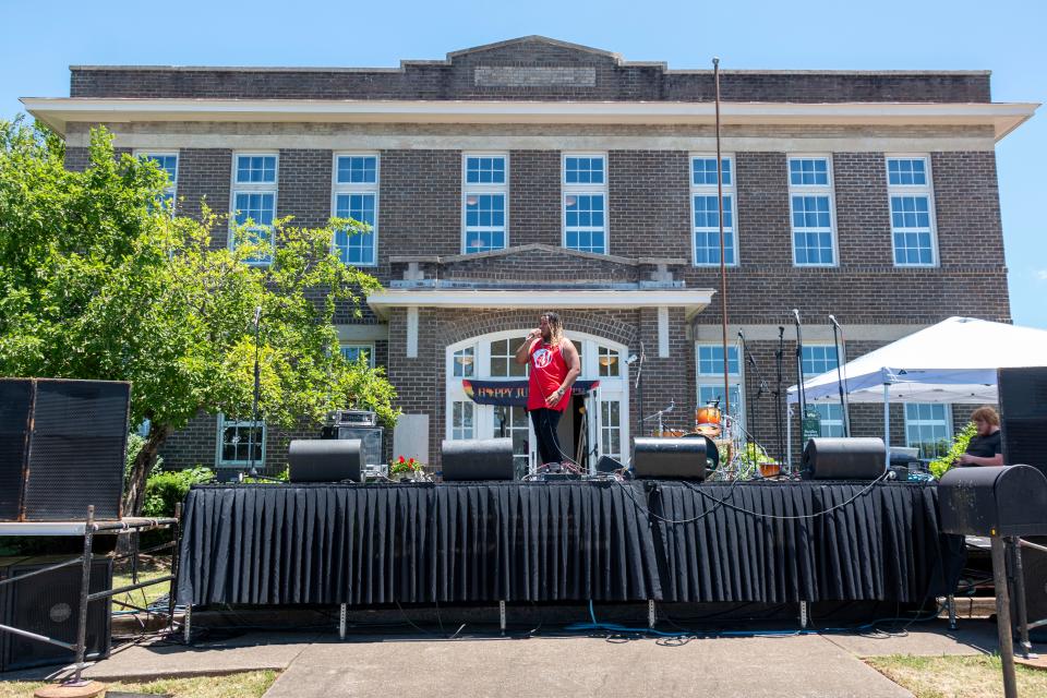 Miles Creed performs on stage in front of the Bradley Academy Museum on Saturday, June, 18, 2022, during the Juneteenth festival held at Bradley Academy Museum and Cultural Center.