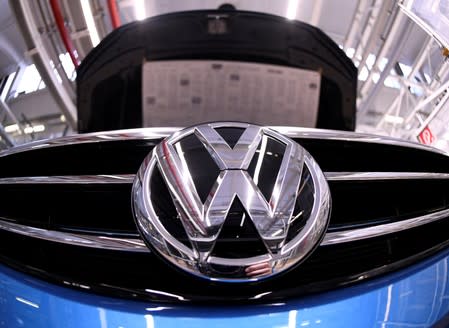 FILE PHOTO: A Volkswagen logo is pictured in a production line at the Volkswagen plant in Wolfsburg