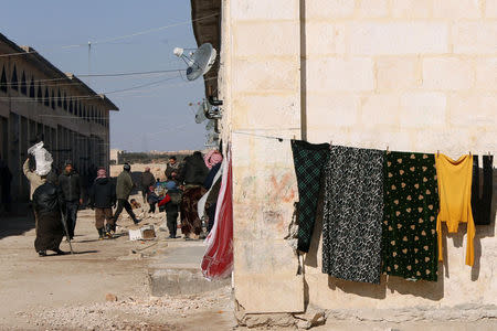 Displaced people walk in Aleppo's Jibreen shelter, Syria February 1, 2017. REUTERS/Omar Sanadiki