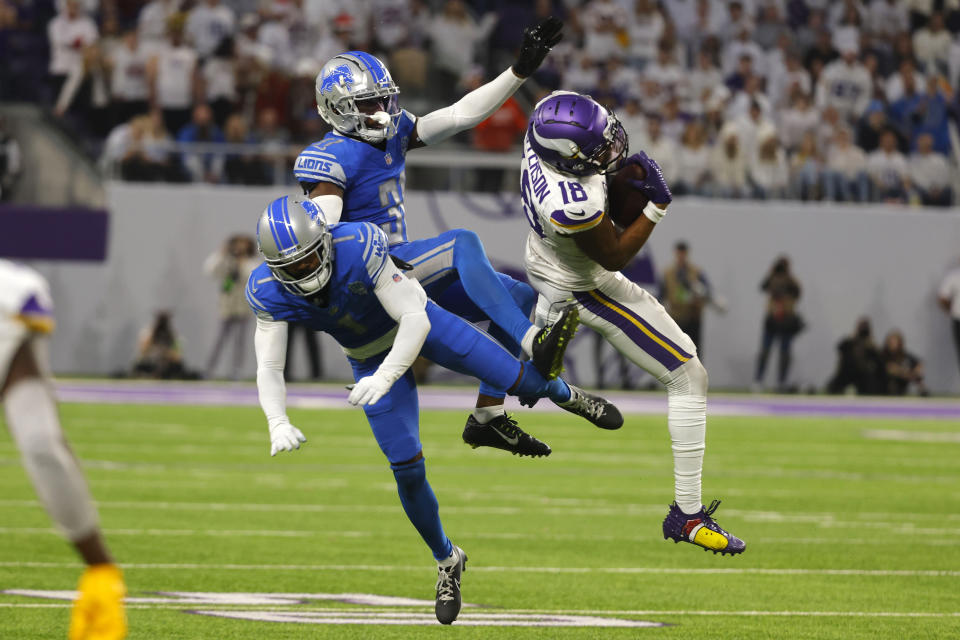 Minnesota Vikings wide receiver Justin Jefferson (18) catches a pass in front of Detroit Lions cornerback Cameron Sutton (1) and safety Kerby Joseph (31) during the second half of an NFL football game, Sunday, Dec. 24, 2023, in Minneapolis. The Lions won 30-24. (AP Photo/Bruce Kluckhohn)