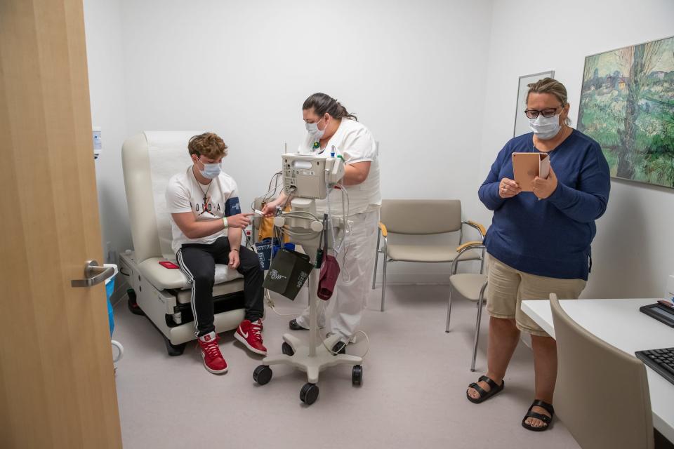 After receiving radiation, Chase Smith has his vitals taken inside Cleveland Clinic Taussig Cancer Center as his mother Kelli connects to a video call with Chase's wife Sadie and his father Brad on Monday, June 1, 2020. Due to COVID-19 restrictions, only one guest is able to accompany Chase to his appointment. 