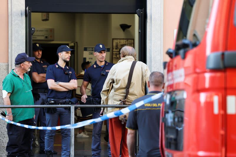 Members of the police work at the scene following a fire in a retirement home in Milan