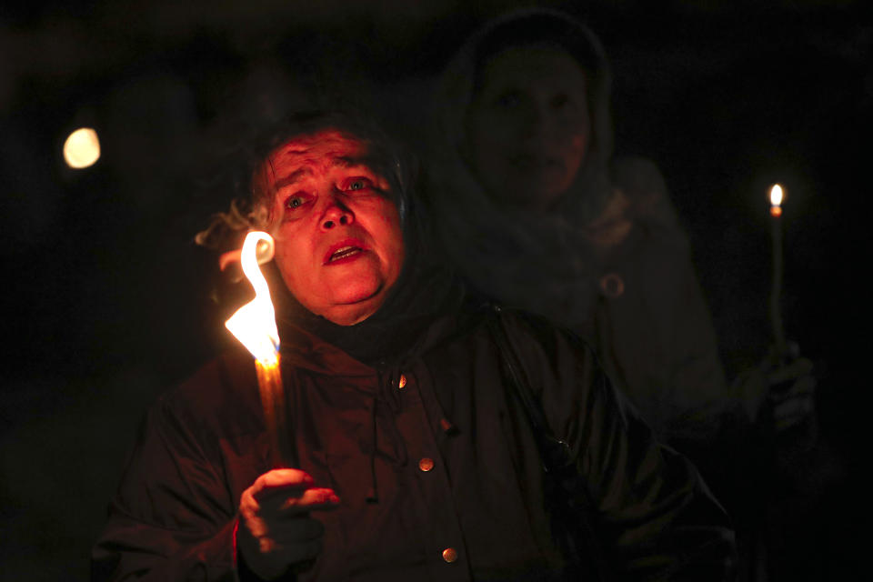 An orthodox worshiper sings during a religious service in the Black Sea port of Constanta, Romania, shortly before midnight on Tuesday, May 26, 2020. Romanian Orthodox Archbishop Teodosie rescheduled the Orthodox Easter service, which was to be held in mid-April, to offer worshippers an opportunity to celebrate Easter properly after the cancelling of the original April 19 service due to the national lockdown imposed because of the coronavirus pandemic. (AP Photo/Vadim Ghirda)