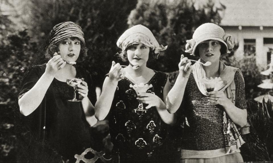 <p>Fashionably dressed triplets pose for a photo as they enjoy frozen treats.</p>