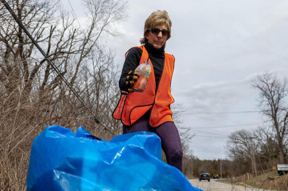 Dianne Siegel picks up plastic debris along East Blue Ridge Boulevard on Wednesday, March 15, 2023, in Kansas City.