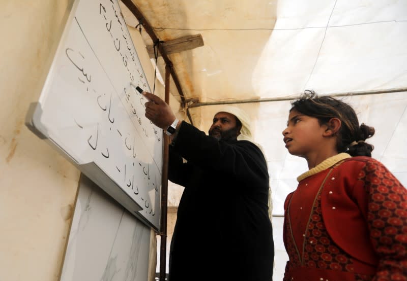 A student recites the Arabic alphabet at a makeshift school in a tent in Azaz