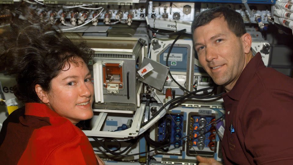 Mission Specialist Laurel B. Clark and Commander Rick D. Husband are seen near supportive equipment for experiments on the SPACEHAB Research Double Module aboard the space shuttle Columbia. - NASA
