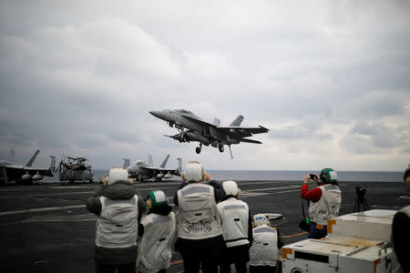 A U.S. F18 fighter jet lands on the deck of U.S. aircraft carrier USS Carl Vinson during an annual joint military exercise called "Foal Eagle" between South Korea and U.S., in the East Sea, South Korea, March 14, 2017. REUTERS/Kim Hong-Ji