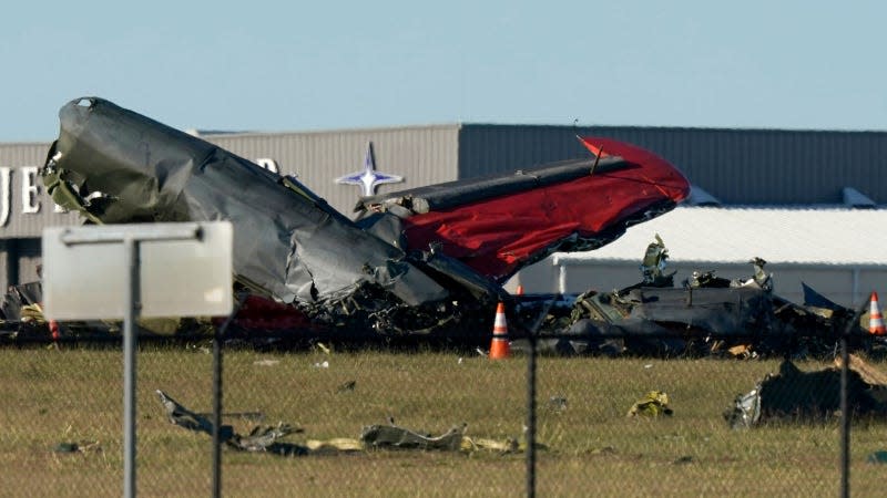 A photo of the aftermath of a mid-air collision between two vintage planes. 