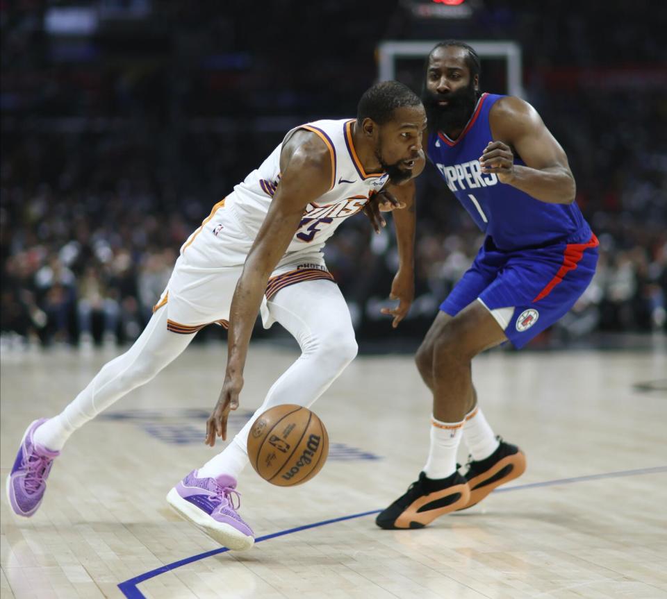 Kevin Durant drives past James Harden.