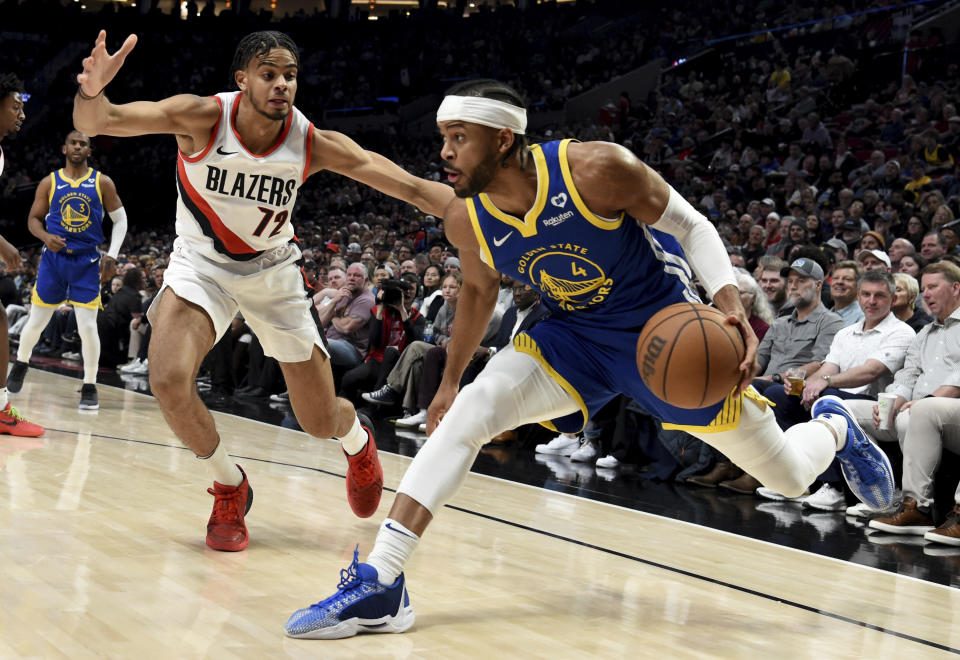 Golden State Warriors guard Moses Moody (4) drives to the basket against Portland Trail Blazers guard Rayan Rupert (72) during the first half of an NBA basketball game in Portland, Ore., Thursday, April 11, 2024. (AP Photo/Steve Dykes)